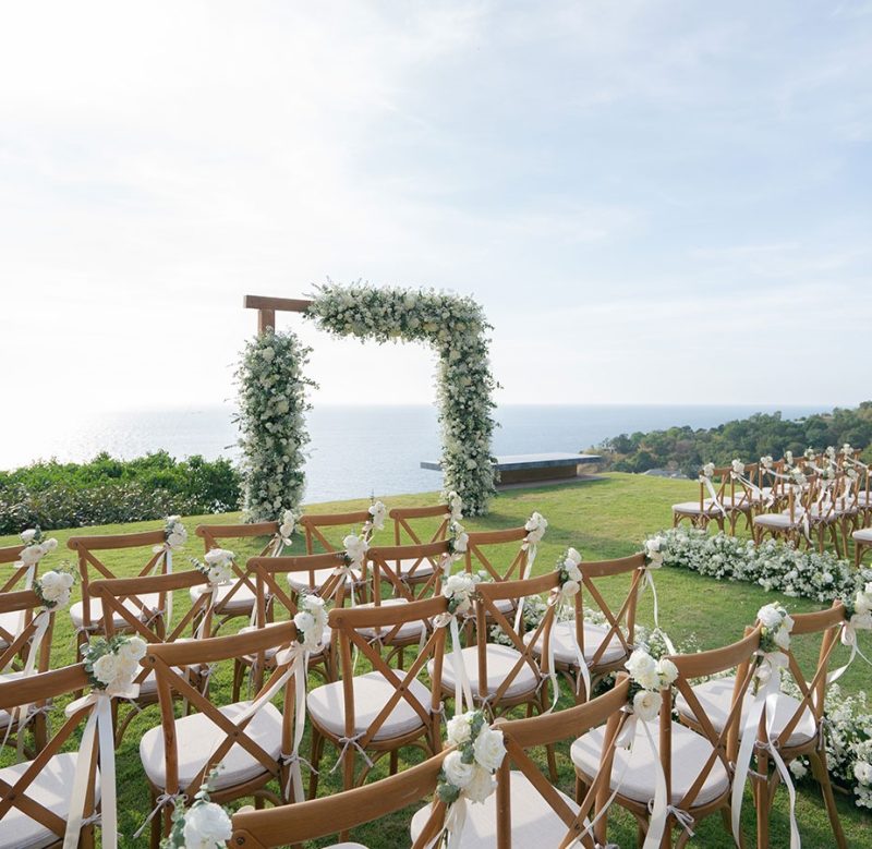 Destination wedding ceremony in Phuket with ocean view and tropical floral arch